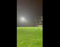 Man Carries Soccer Net Across Soccer Field