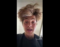 Guy tests knee reflex with massage gun 