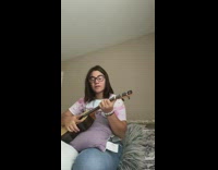 Girl tries to play ukulele loud music