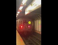 Man sit on window ride behind subway train