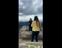 Girl black sweater dance on mountain cloudy