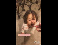Girl pretends to feed baby pumpkin pie 