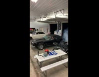 Two cars rev engine garage auto shop 