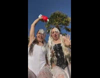 Two girls pour milk on each other 