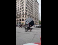 Man spins with the cube riding motorcycle 