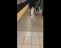 Skater red Nike shoes kickflips on skateboard and fails in subway station