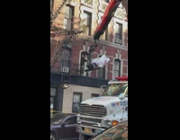 Forklift carries heavy item out of second floor 
