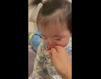 Mom puts finger in crying babys mouth 
