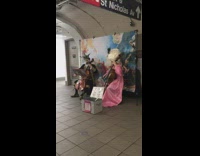 two people in victorian clothing and masks play cello
