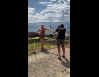 Person cross-dress selfie with photographer at pyramids