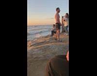 shirtless man handstand sunset rock