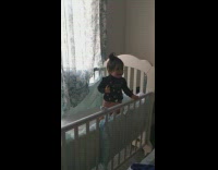 Baby dances to Spanish song in crib