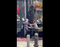 Guy Feeds Dog Date from Across Table 