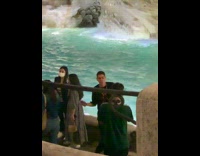 Man airpods rap video shoot in front of waterfalls