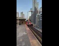Two guys ride outside behind moving train