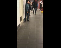 Older Woman Blue Coats Bangs Shoulder Against Subway Wall