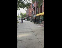 Girl black tank top black railings sidewalk