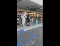 Three women dance outside alaska airport departure