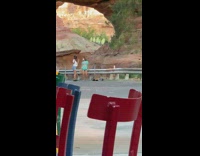 Two girls dance soap bubbles stone arch 