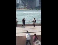 Woman white top dance video near river