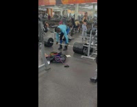 Man Struggles to Lift Heavy Weights at Gym