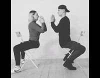 Guy girl sit backwards play clapping game 