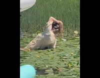 Girl hold hair swim in pond water