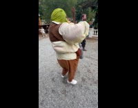 Collab VIBES - Woman wears shrek costume dance hold drinks