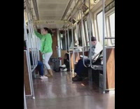 Green sweater girl stands dances train speaker 