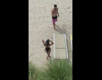 Black bikini girl brown chair beach sand 