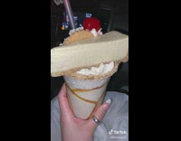Milkshake with entire cheesecake on top of cup 
