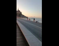 Woman red dress poses near the beach