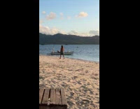 Woman walks at beach for drone video