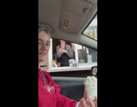 Girl puts feet in pup cup whipped cream in car drive thru