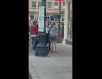 Girl hold newspaper sidewalk teach friend camera