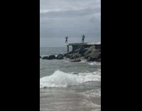 shirtless man edge of old pier pose