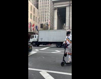 Guy unicorn astronaut suit on scooter drives by 