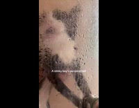 Cat holding onto shower door