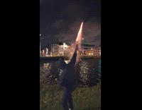 Guy lights up fireworks on the bottle