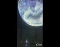 Girl looks at planet at observatory