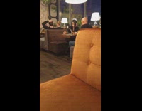 Black shirt girl orange booth seats selfie 