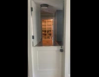 Dog called peek above door bottom half