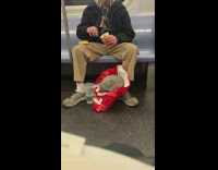 Guy eats a tub of ice cream using his metro card as a spoon on subway