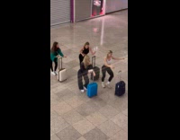 Four women luggage dance at the airport