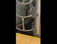 Grey cylinder tube between subway cars 