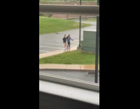 Collab IITW - Two women black and gray jackets tiktok dance on the parking lot after the rain