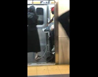 Man irons clothes on ironing board on subway train