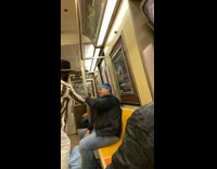 Guy Wearing a Cowboy Hat Pour Drink into Guys Mouth on Subway