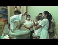 Baby reaches for high five at baptism 