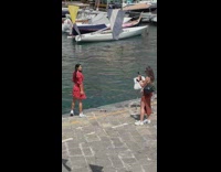 Woman in red outfit turn around pose at the docks